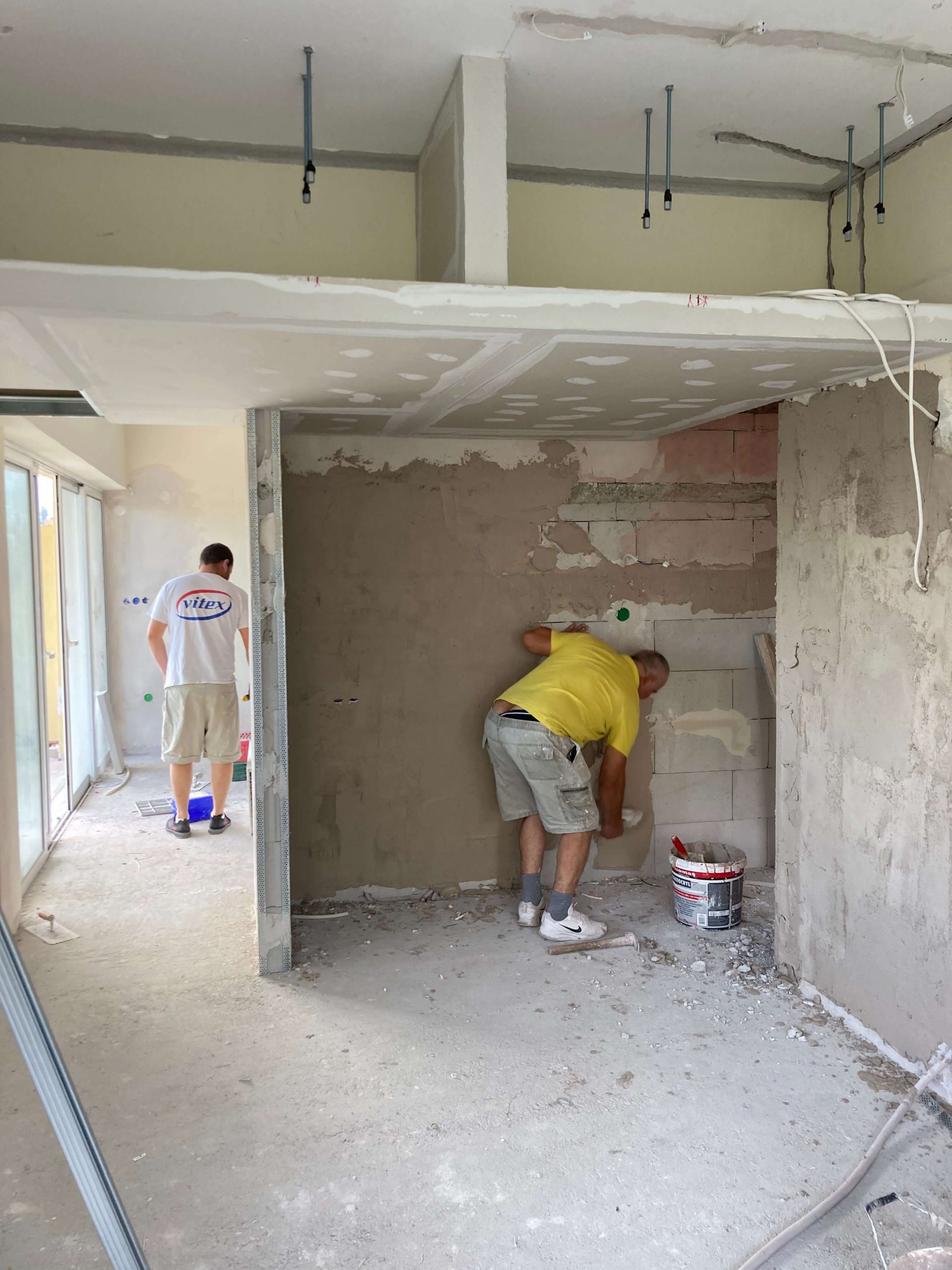 Construction photo of kitchen being plastered and prepared