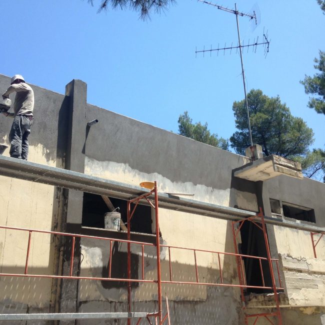 Exterior mainetenance on building in Greece