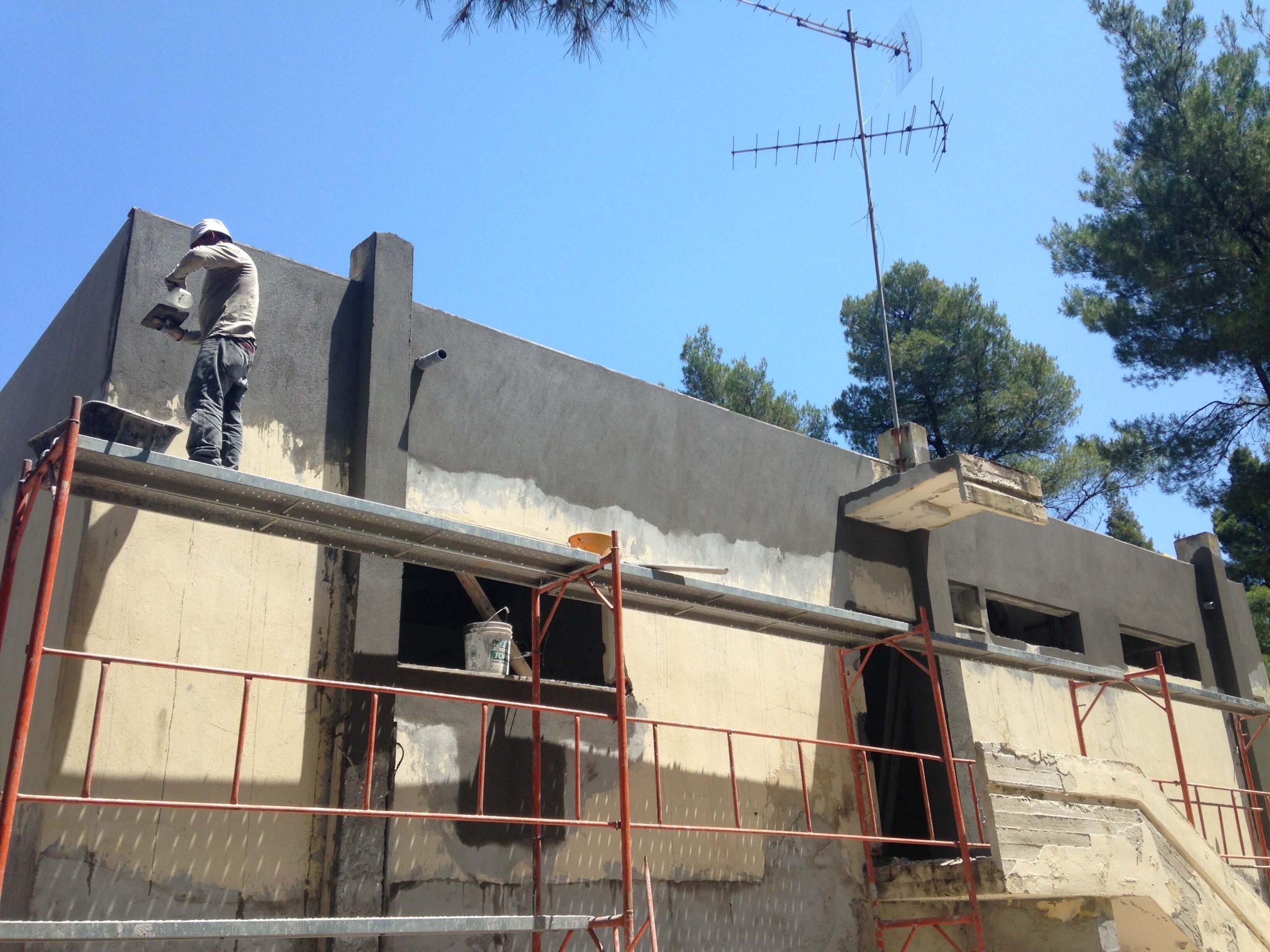 Exterior mainetenance on building in Greece