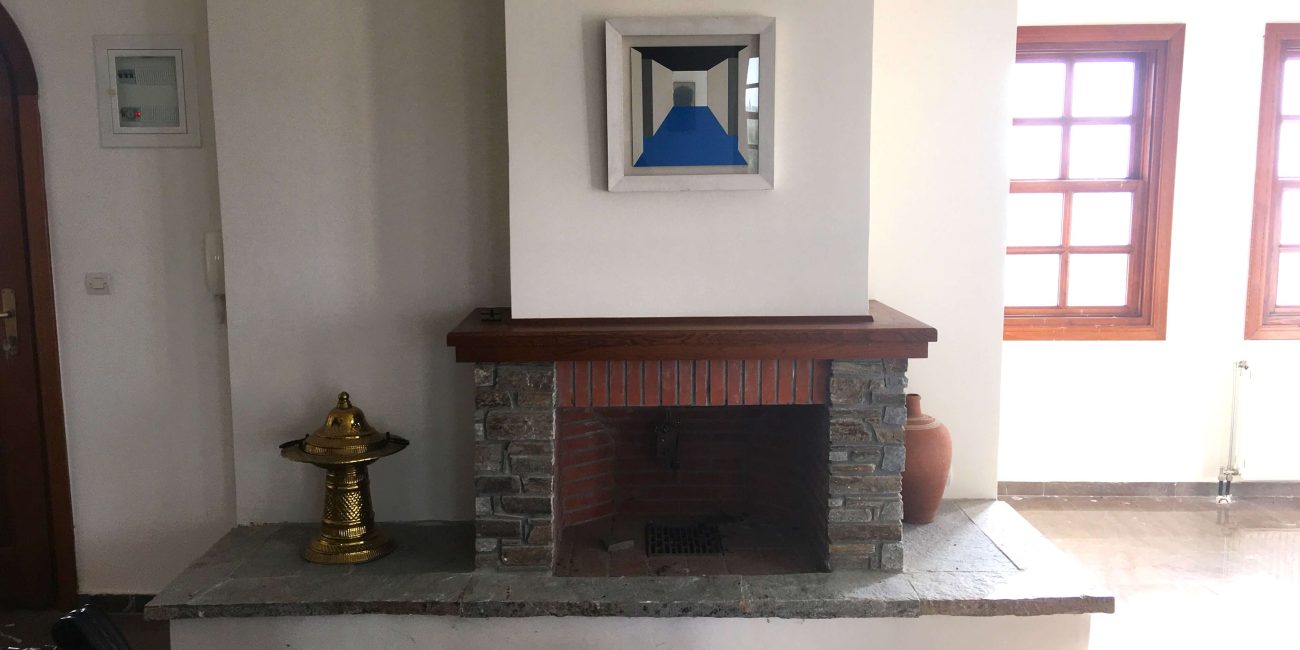 Simple room with medium-sized stone fireplace