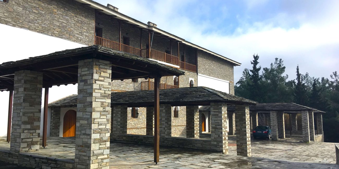 Patio with large building and outbuildings