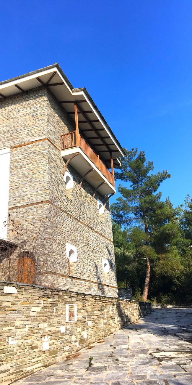Tall stone building next to rural area